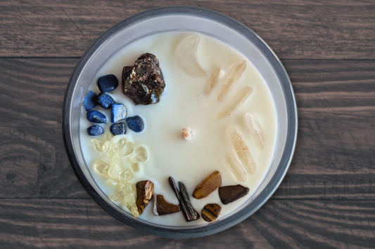 amber, lapis lazuli, citrine, tigers eye, and clear quartz crystals on an apples and maple bourbon candle